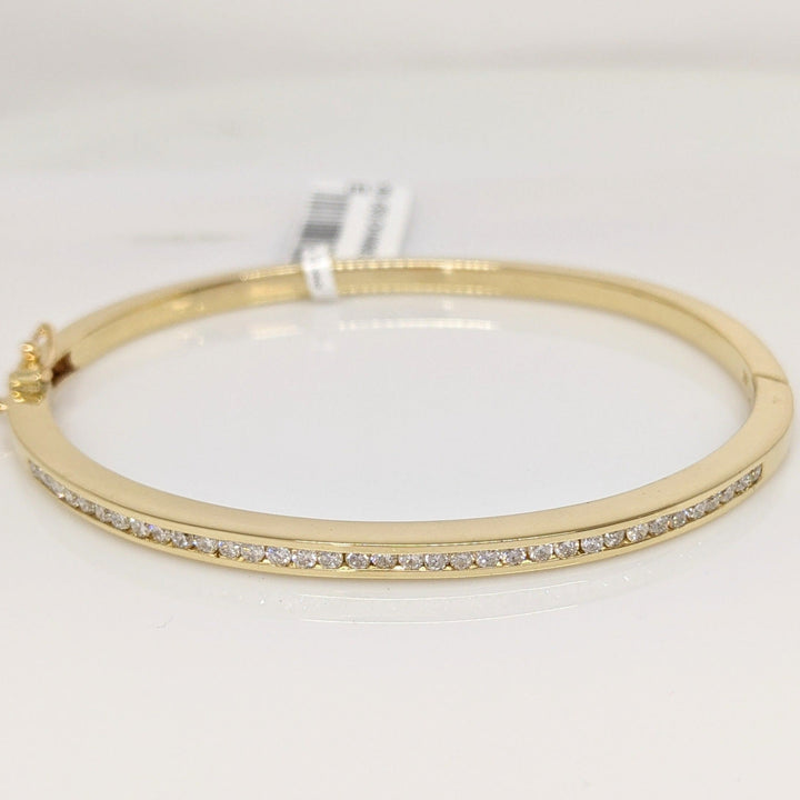 14K .70 CARAT TOTAL WEIGHT I1 I DIAMOND ROUND (35) CHANNEL SET ESTATE BANGLE 15.8 GRAMS