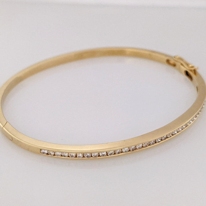 14K .70 CARAT TOTAL WEIGHT I1 H DIAMOND ROUND (35) CHANNEL SET ESTATE BANGLE 11.9 GRAMS