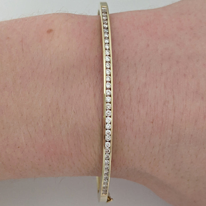 14K .70 CARAT TOTAL WEIGHT I1 H DIAMOND ROUND (35) CHANNEL SET ESTATE BANGLE 11.9 GRAMS
