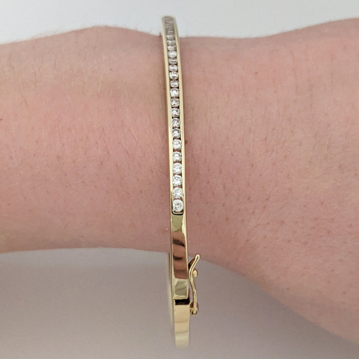 14K .70 CARAT TOTAL WEIGHT I1 H DIAMOND ROUND (35) CHANNEL SET ESTATE BANGLE 11.9 GRAMS