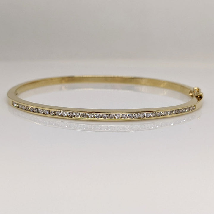 14K .70 CARAT TOTAL WEIGHT I1 H DIAMOND ROUND (35) CHANNEL SET ESTATE BANGLE 11.9 GRAMS