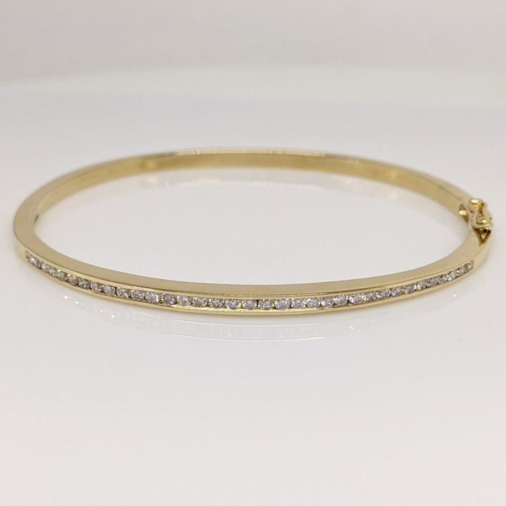 14K .70 CARAT TOTAL WEIGHT I1 H DIAMOND ROUND (35) CHANNEL SET ESTATE BANGLE 11.9 GRAMS