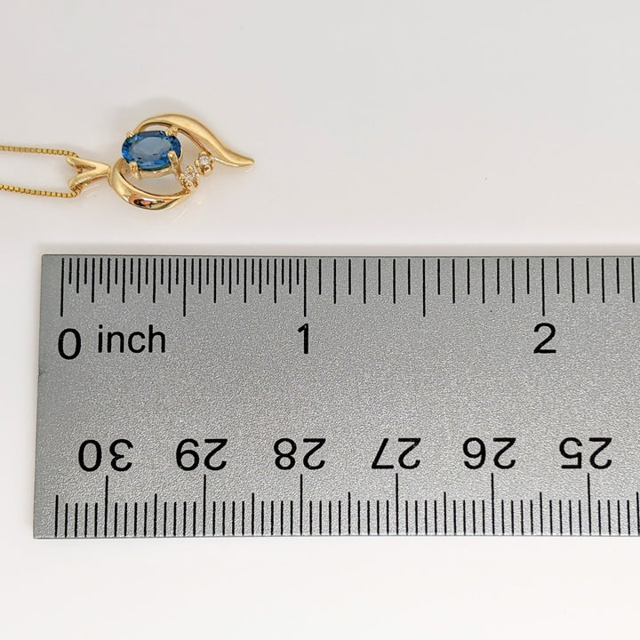 14K BLUE TOPAZ OVAL 4X6 WITH (2) MELEE FREE FORM ESTATE PENDANT & CHAIN 2.3 GRAMS