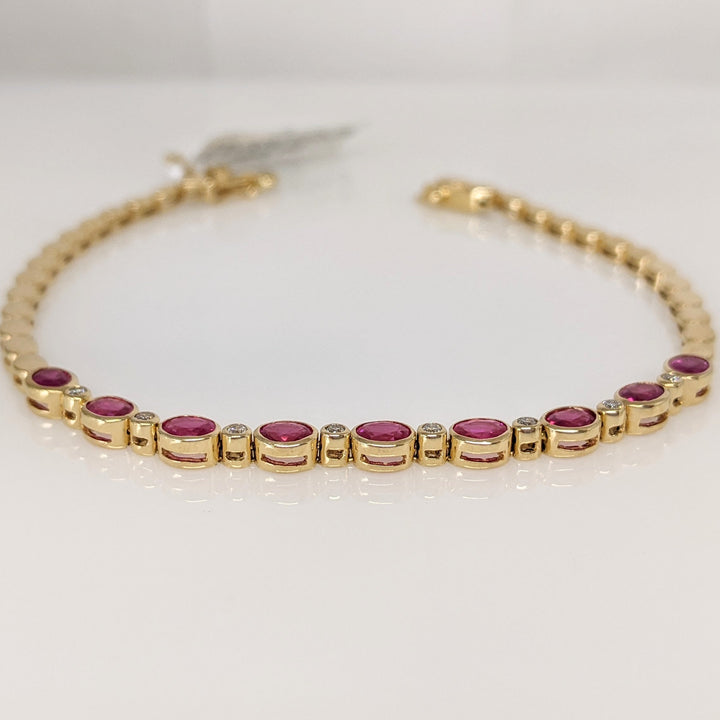 14K RUBY OVAL 3X4 (9) WITH .12 DIAMOND TOTAL WEIGHT ESTATE BRACELET 8.0 GRAMS
