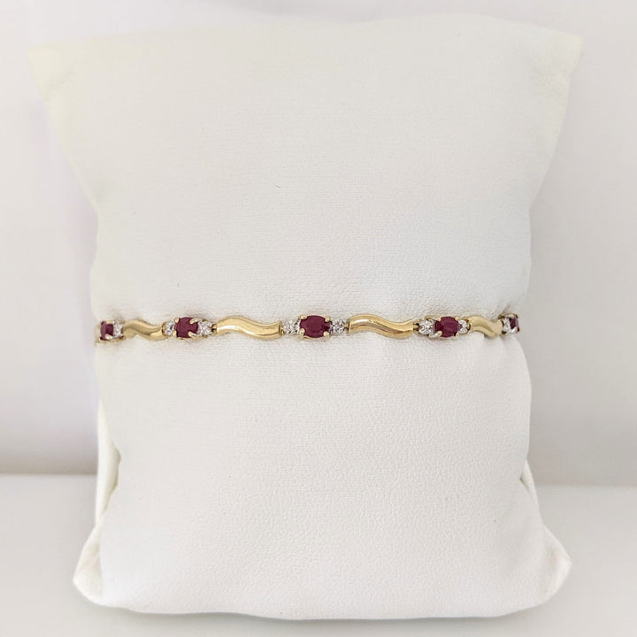 10K RUBY OVAL (9) 3X4 WITH (2) MELEE ESTATE BRACELET 3.5 GRAMS