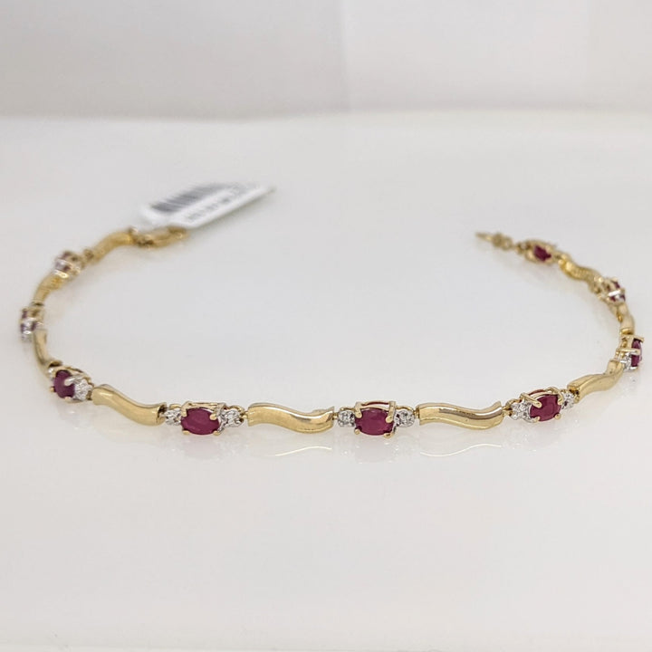 10K RUBY OVAL (9) 3X4 WITH (2) MELEE ESTATE BRACELET 3.5 GRAMS