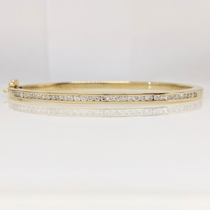 14K .70 CARAT TOTAL WEIGHT I1 I DIAMOND ROUND (35) CHANNEL SET ESTATE BANGLE 15.8 GRAMS