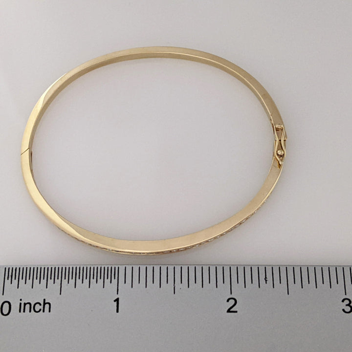 14K .70 CARAT TOTAL WEIGHT I1 H DIAMOND ROUND (35) CHANNEL SET ESTATE BANGLE 11.9 GRAMS