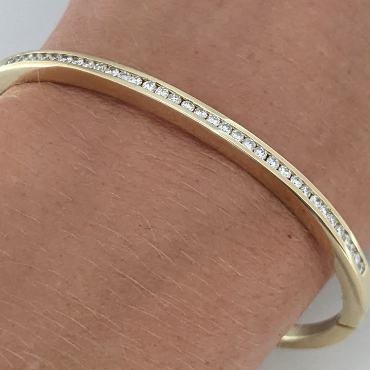 14K .70 CARAT TOTAL WEIGHT I1 I DIAMOND ROUND (35) CHANNEL SET ESTATE BANGLE 15.8 GRAMS