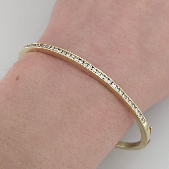 14K .70 CARAT TOTAL WEIGHT I1 H DIAMOND ROUND (35) CHANNEL SET ESTATE BANGLE 11.9 GRAMS