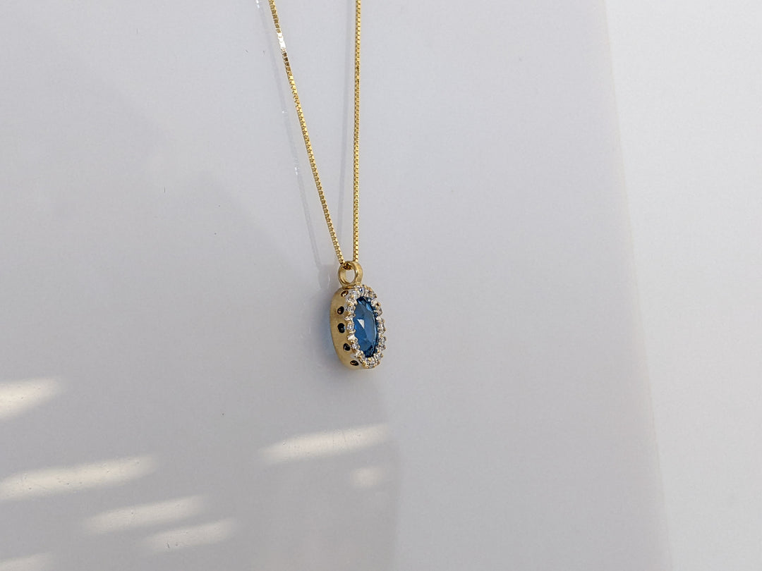 14K BLUE TOPAZ OVAL 5X7 WITH .12 DIAMOND TOTAL WEIGHT ESTATE PENDANT AND CHAIN 1.8 GRAMS