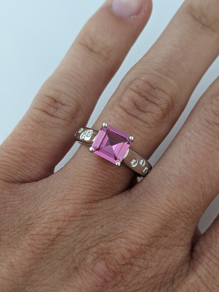 PLATINUM PINK SAPPHIRE PRINCESS CUT 1.41 CARAT TOTAL WITH .12 DIAMOND TOTAL WEIGHT 5.9 GRAMS