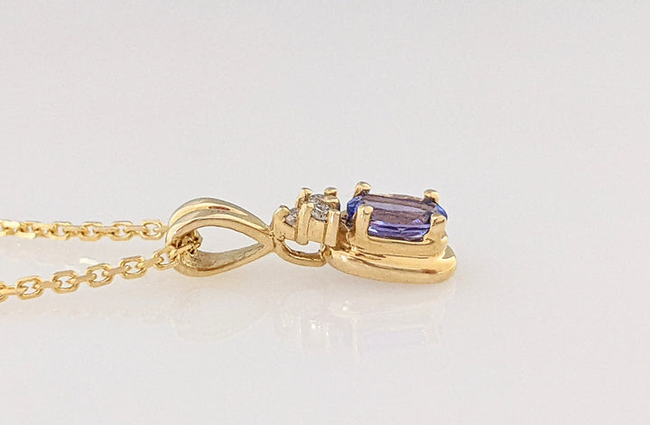 14K TANZANITE OVAL 4X6 WITH (3) MELEE ESTATE 3.6 GRAMS