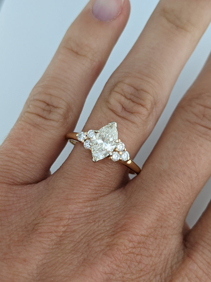 14K 1.36 CARAT TOTAL WEIGHT I1 K DIAMOND MARQUISE WITH (6) ROUND MELEE 3.0 GRAMS