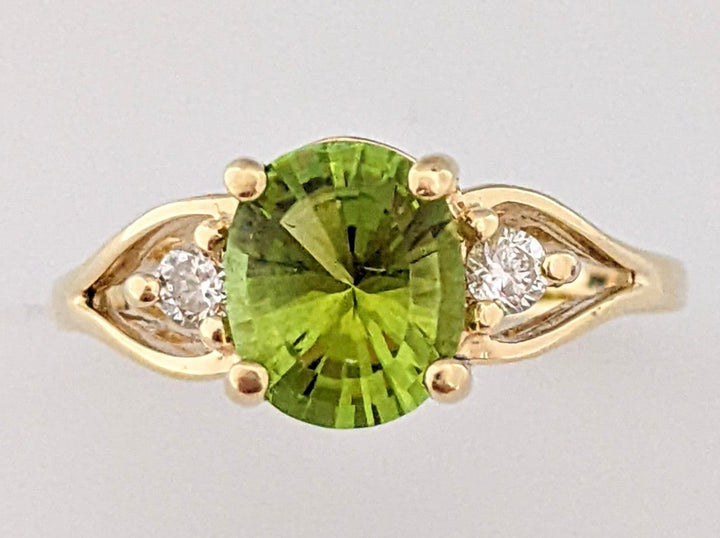 14K PERIDOT OVAL 7X8 WITH (2) .10DTW ESTATE RING 3.6 GRAMS