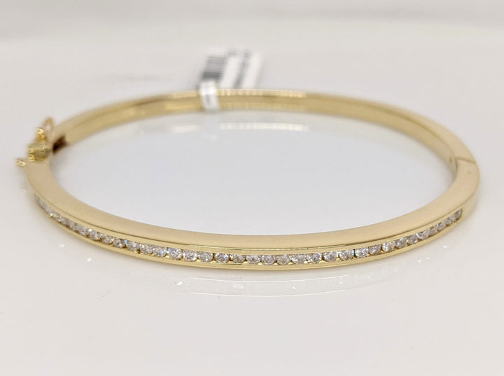 14K .70 CARAT TOTAL WEIGHT I1 I DIAMOND ROUND (35) CHANNEL SET ESTATE BANGLE 15.8 GRAMS