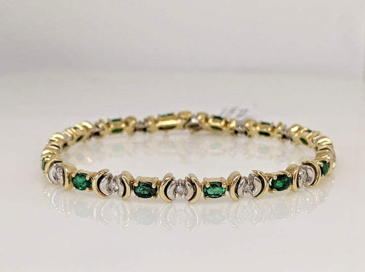 14K TWO TONE EMERALD (14) 3X4 OVAL AND (14) DIAMOND ROUND TENNIS BRACELET 14.9 GRAMS