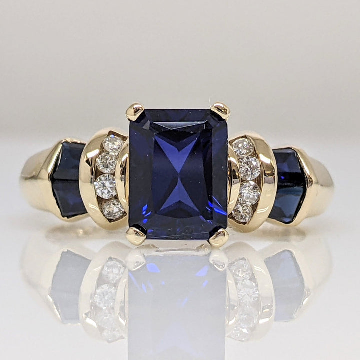 10K LAB CREATED SAPPHIRE EMERALD CUT 6X8 WITH (4) BAGUETTE AND (8) DIAMOND .12CTW ESTATE RING 4.1 GRAMS