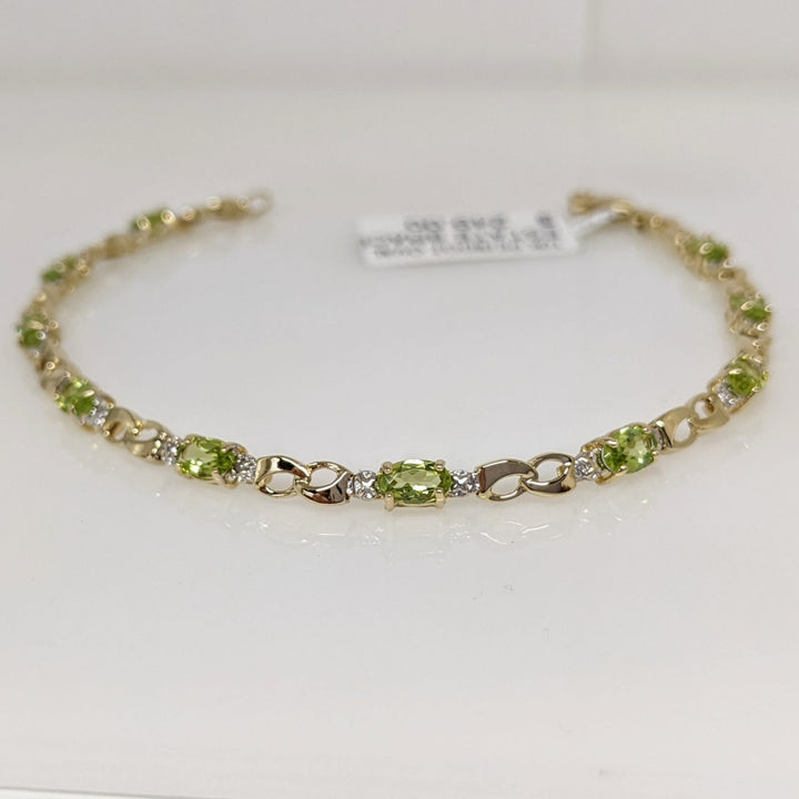 10K PERIDOT OVAL (10) 3X5 WITH (2) MELEE ESTATE BRACELET 4.0 GRAMS