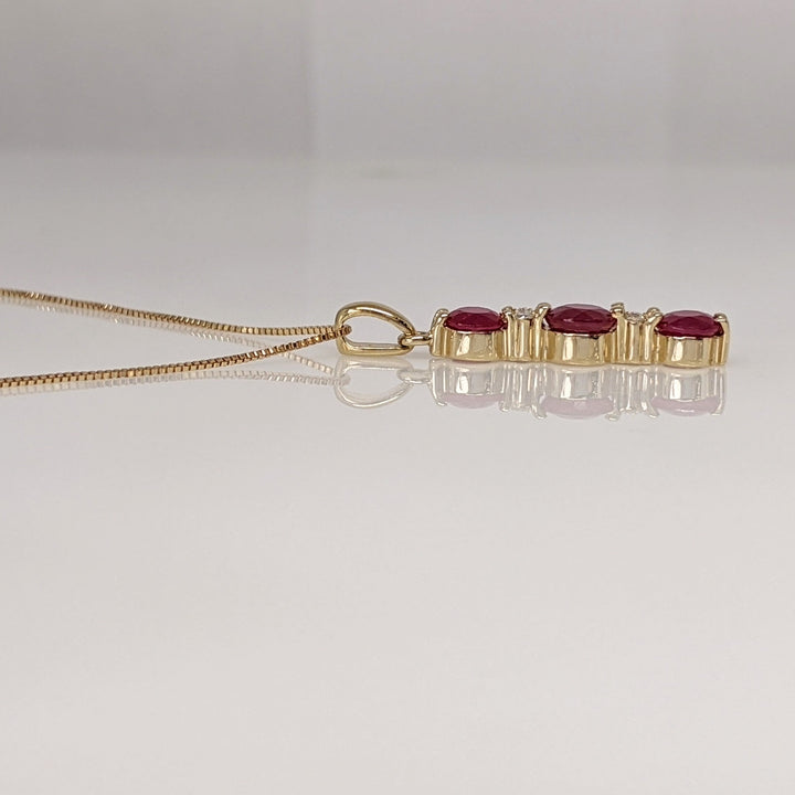 14K RUBY ROUND (1) 5.5MM (2) 4.5MM WITH (4) MELEE ESTATE PENDANT & CHAIN 2.6 GRAMS