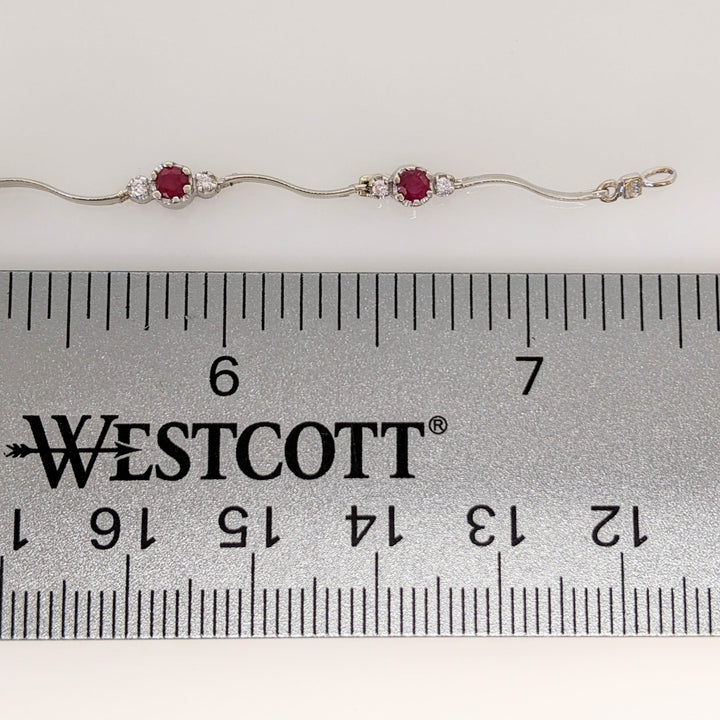 14K WHITE RUBY ROUND (8) 3MM WITH .16 DIAMOND TOTAL WEIGHT (16) ESTATE WAVY BRACELET 4.3 GRAMS