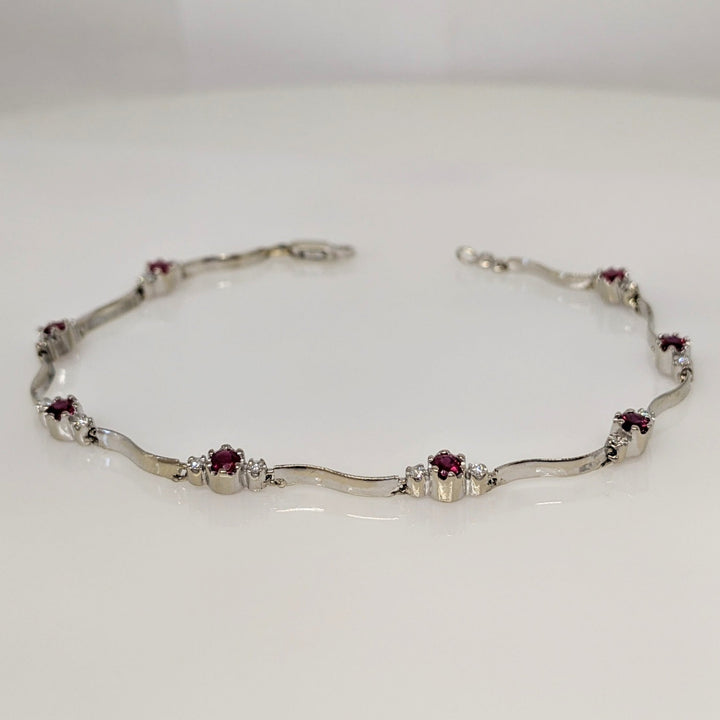 14K WHITE RUBY ROUND (8) 3MM WITH .16 DIAMOND TOTAL WEIGHT (16) ESTATE WAVY BRACELET 4.3 GRAMS