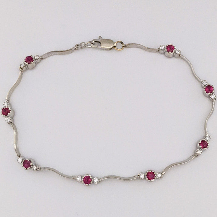 14K WHITE RUBY ROUND (8) 3MM WITH .16 DIAMOND TOTAL WEIGHT (16) ESTATE WAVY BRACELET 4.3 GRAMS
