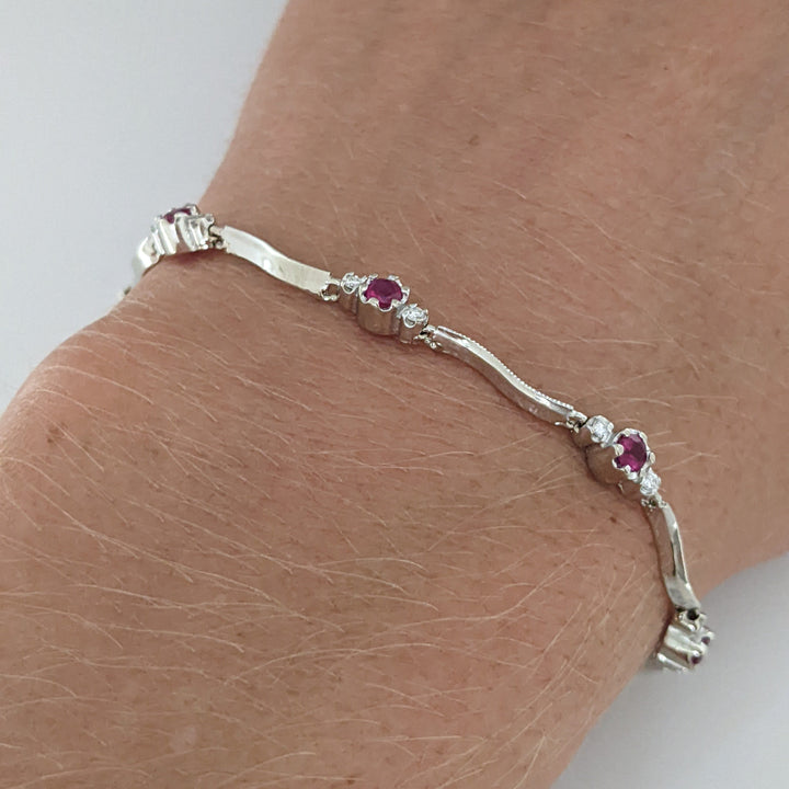 14K WHITE RUBY ROUND (8) 3MM WITH .16 DIAMOND TOTAL WEIGHT (16) ESTATE WAVY BRACELET 4.3 GRAMS