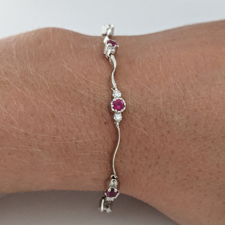 14K WHITE RUBY ROUND (8) 3MM WITH .16 DIAMOND TOTAL WEIGHT (16) ESTATE WAVY BRACELET 4.3 GRAMS