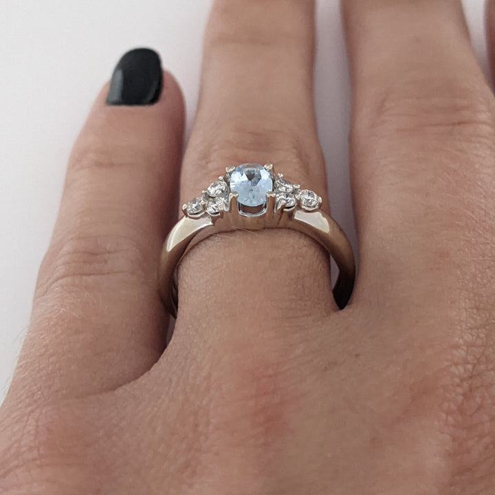 14K WHITE AQUAMARINE OVAL 4X6 WITH .18 DIAMOND TOTAL WEIGHT (6) ROUND ESTATE RING 3.1 GRAMS