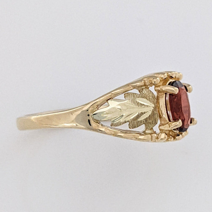 10K TWO-TONE GARNET OVAL 4X6 WITH ROSE LEAF ESTATE RING 2.2 GRAMS