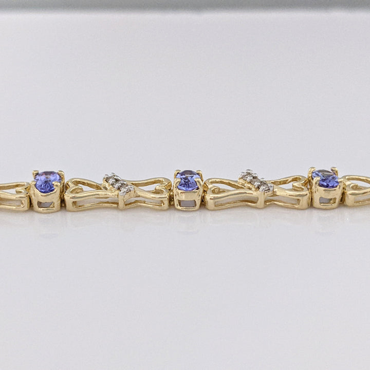 14K TANZANITE OVAL (11) 3X5 WITH .33 DIAMOND TOTAL WEIGHT (33) ESTATE BRACELET 10.5 GRAMS