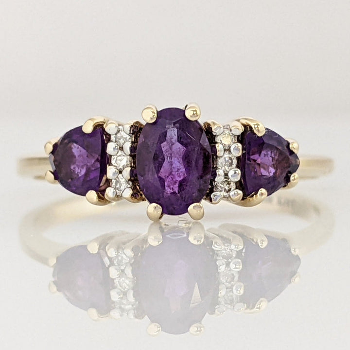 10K AMETHYST OVAL 4X6 WITH (2) TRILLION 4MM WITH (6) MELEE ESTATE RING 1.9 GRAMS
