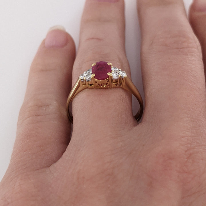 18K RUBY OVAL 4.9X6.6 OVAL WITH .18 DIAMOND TOTAL WEIGHT (6) ROUND ESTATE RING 3.4 GRAMS