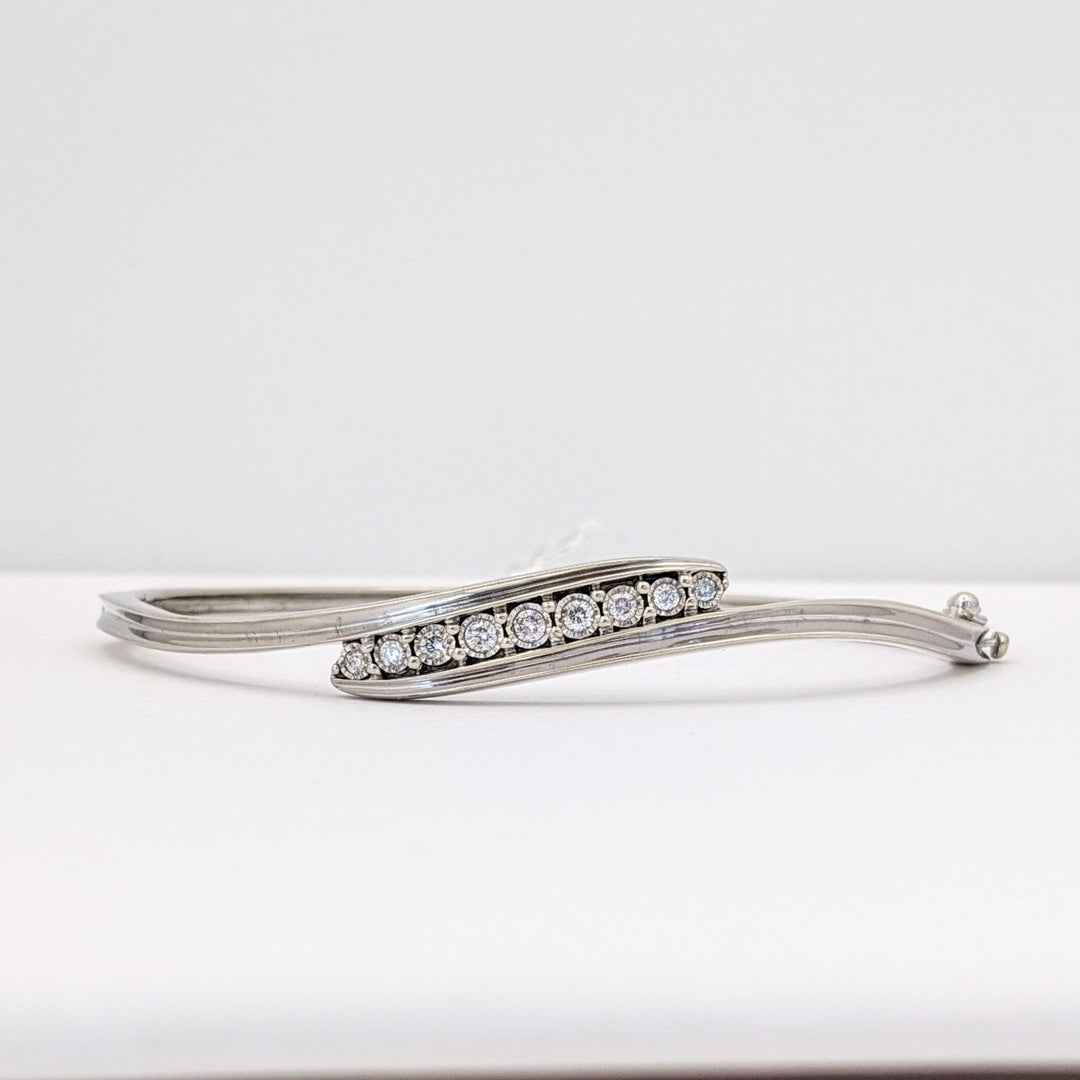 STERLING SILVER .27 CARAT TOTAL WEIGHT DIAMOND ROUND (9) ESTATE BYPASS BANGLE 12.2 GRAMS