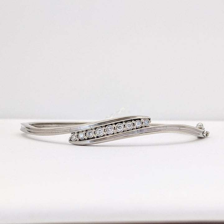 STERLING SILVER .27 CARAT TOTAL WEIGHT DIAMOND ROUND (9) ESTATE BYPASS BANGLE 12.2 GRAMS