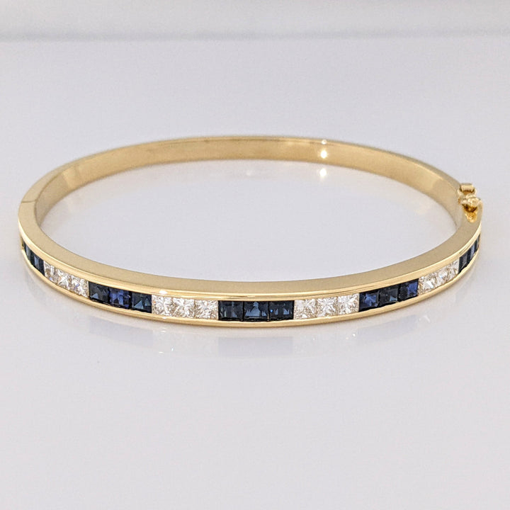 18K SAPPHIRE PRINCESS CUT (15) DIAMOND PRINCESS CUT (12) 2.5MM CHANNEL ESTATE BANGLE 18.2 GRAMS