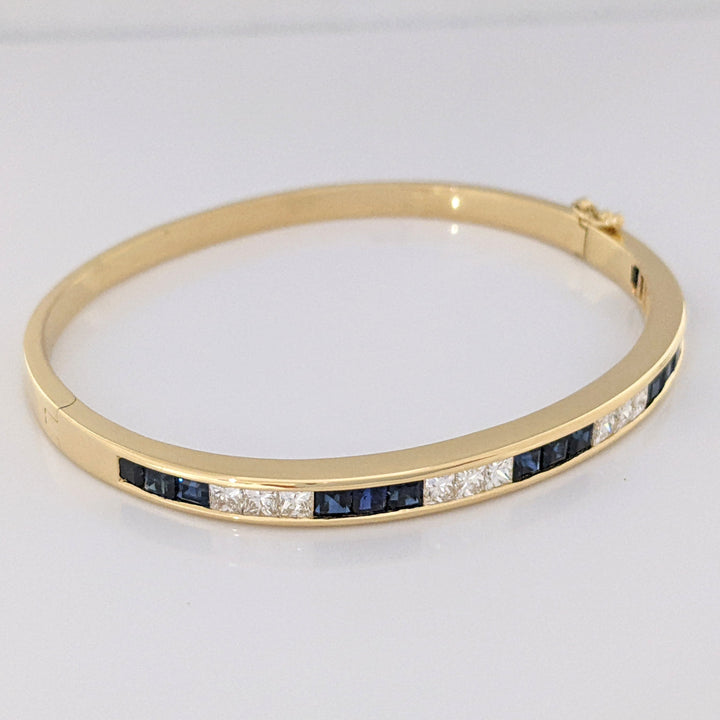 18K SAPPHIRE PRINCESS CUT (15) DIAMOND PRINCESS CUT (12) 2.5MM CHANNEL ESTATE BANGLE 18.2 GRAMS