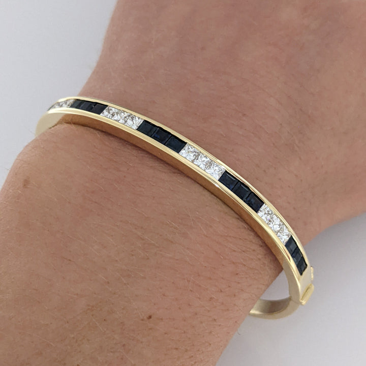 18K SAPPHIRE PRINCESS CUT (15) DIAMOND PRINCESS CUT (12) 2.5MM CHANNEL ESTATE BANGLE 18.2 GRAMS