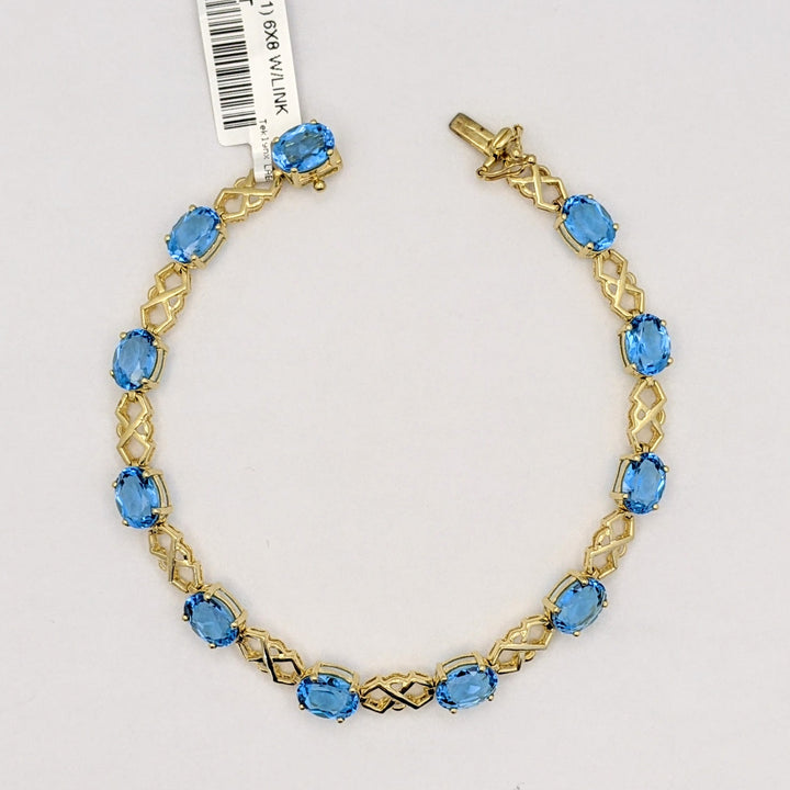 14K BLUE TOPAZ OVAL (11) 6X8 WITH LINK ESTATE BRACELET 10.9 GRAMS