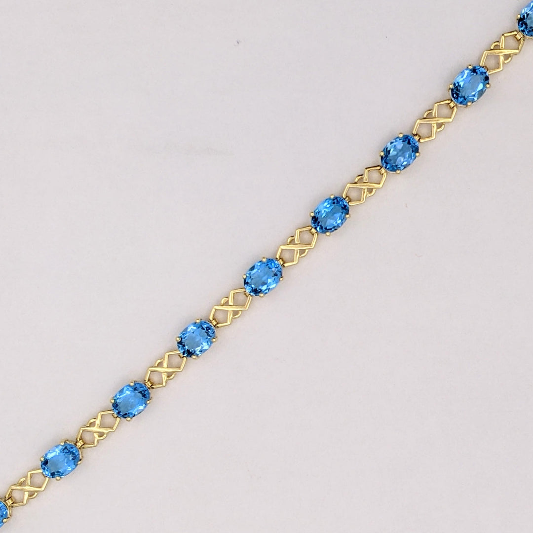 14K BLUE TOPAZ OVAL (11) 6X8 WITH LINK ESTATE BRACELET 10.9 GRAMS