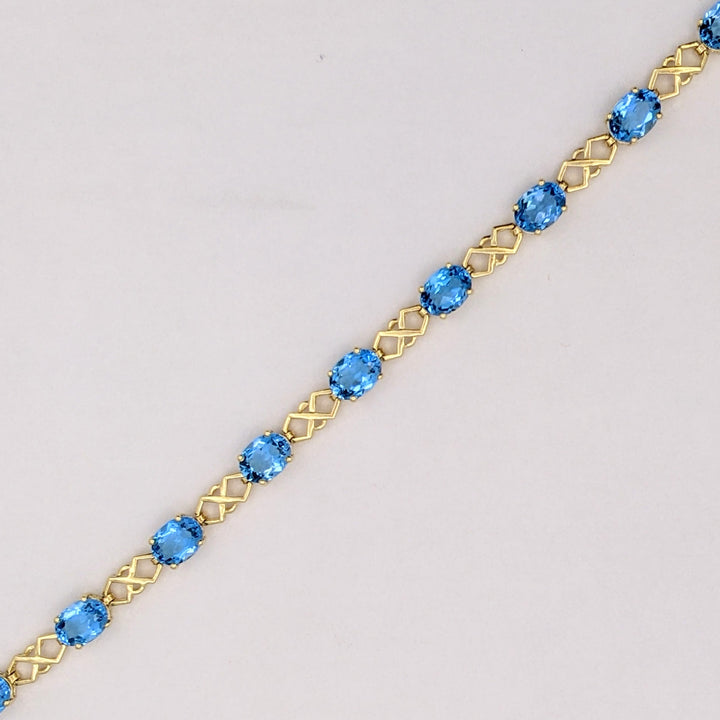14K BLUE TOPAZ OVAL (11) 6X8 WITH LINK ESTATE BRACELET 10.9 GRAMS