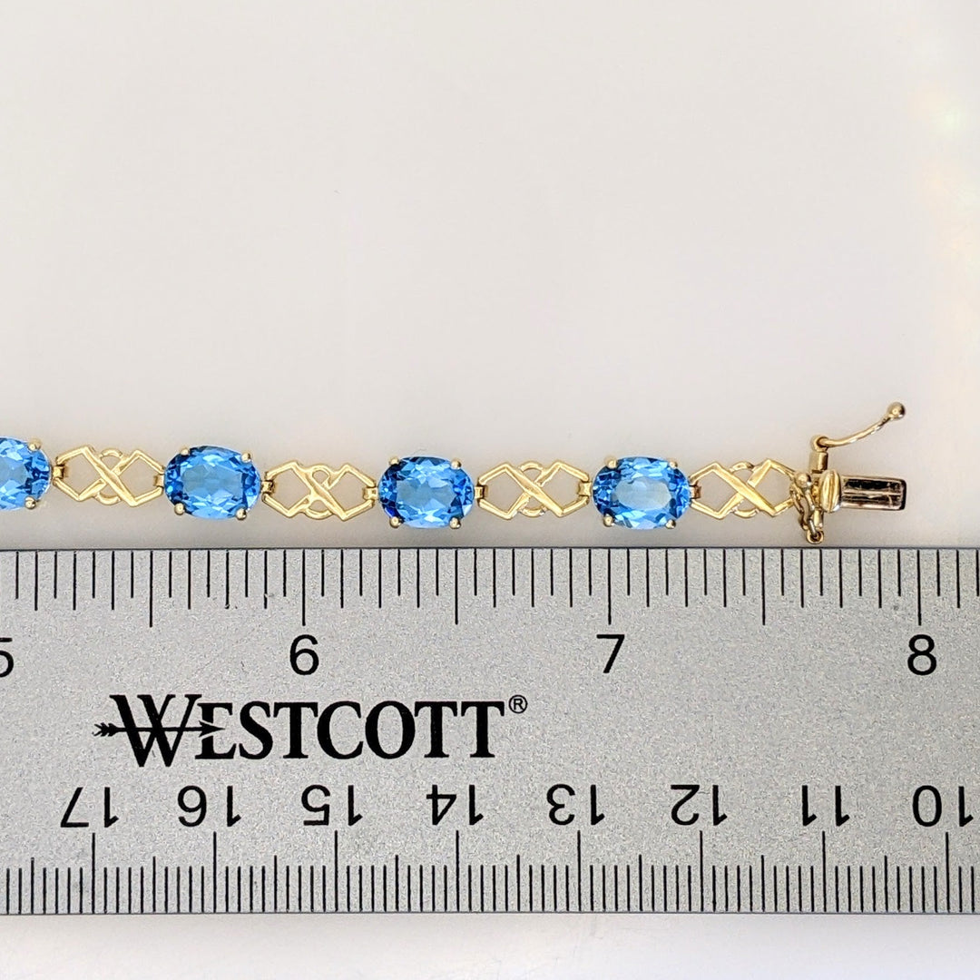 14K BLUE TOPAZ OVAL (11) 6X8 WITH LINK ESTATE BRACELET 10.9 GRAMS