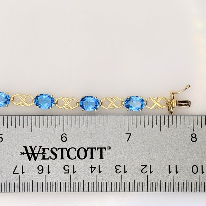 14K BLUE TOPAZ OVAL (11) 6X8 WITH LINK ESTATE BRACELET 10.9 GRAMS