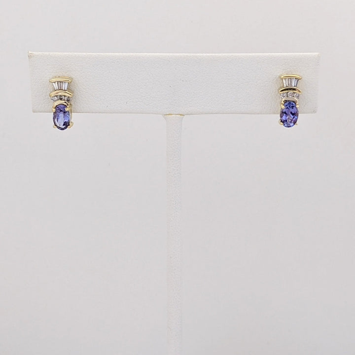 14K TANZANITE OVAL 4X6 WITH .18 DIAMOND TOTAL WEIGHT (6) ROUND (6) BAGUETTE ESTATE EARRINGS 2.1 GRAMS
