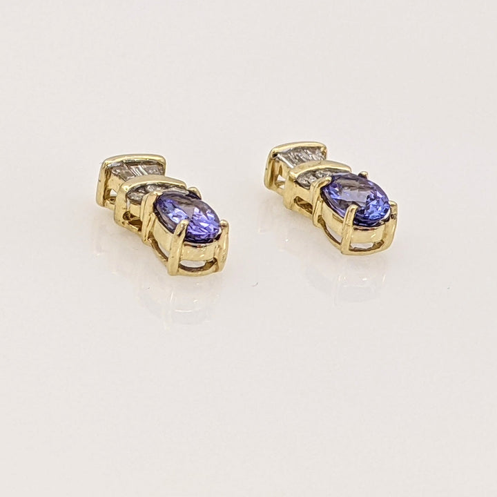 14K TANZANITE OVAL 4X6 WITH .18 DIAMOND TOTAL WEIGHT (6) ROUND (6) BAGUETTE ESTATE EARRINGS 2.1 GRAMS