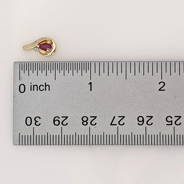10K RUBY PEAR 3X5 WITH MELEE AND GOLD TRIM ESTATE EARRINGS 1.7 GRAMS