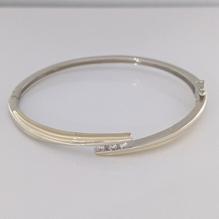 10K TWO-TONE .15 CARAT TOTAL WEIGHT SI2 K DIAMOND ROUND (3) BYPASS ESTATE BANGLE 14.5 GRAMS