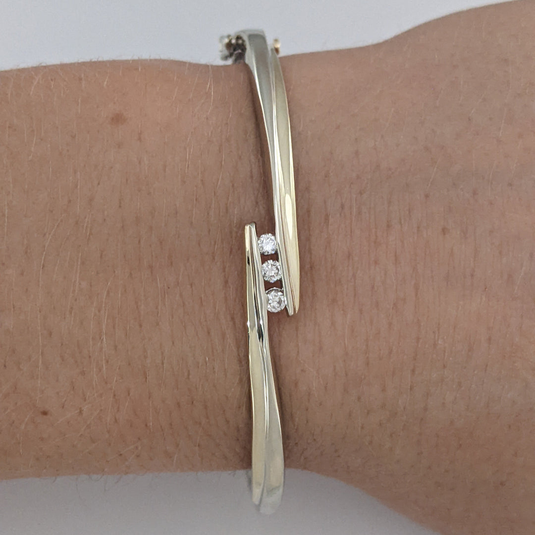 10K TWO-TONE .15 CARAT TOTAL WEIGHT SI2 K DIAMOND ROUND (3) BYPASS ESTATE BANGLE 14.5 GRAMS