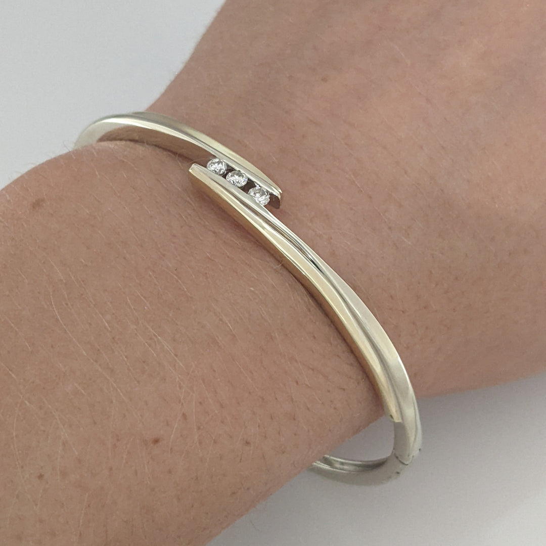 10K TWO-TONE .15 CARAT TOTAL WEIGHT SI2 K DIAMOND ROUND (3) BYPASS ESTATE BANGLE 14.5 GRAMS